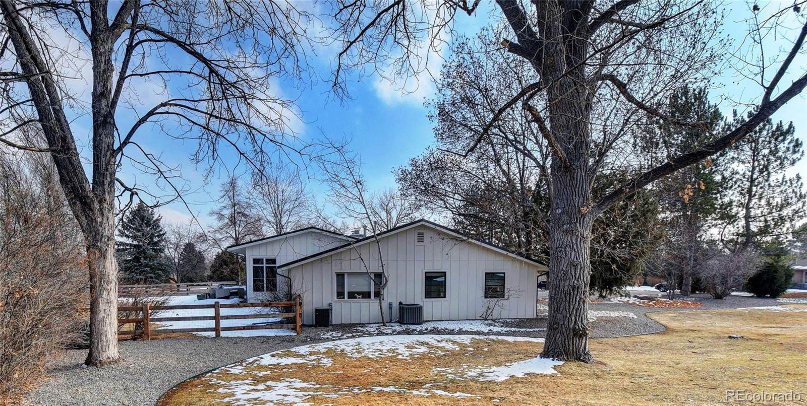 5151 West Wagon Trail Road Littleton, CO 80123 - Photo 4 of 37 a view of a house with a yard covered in snow