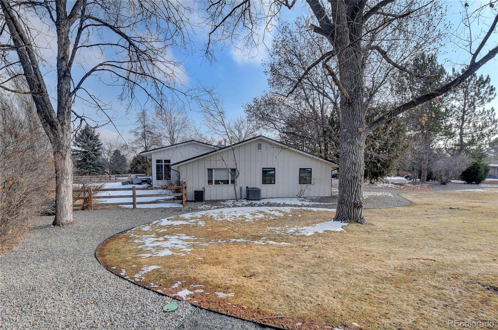 5151 West Wagon Trail Road Littleton, CO 80123 - Photo 5 of 37 a view of a house with a yard covered in snow