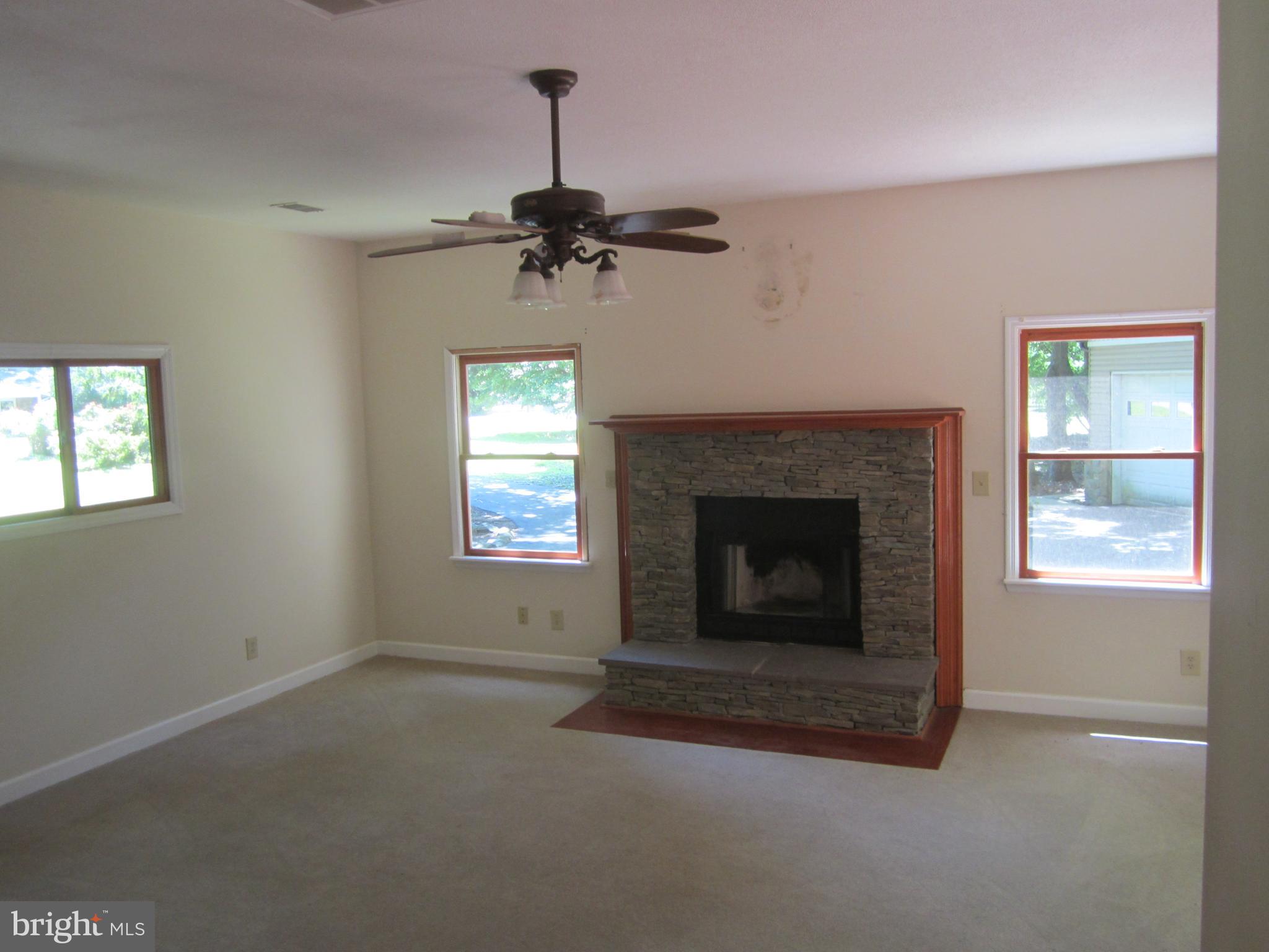 3421 Holland Cliffs Road Huntingtown, MD 20639 - Photo 2 of 19 a living room with furniture and a fireplace