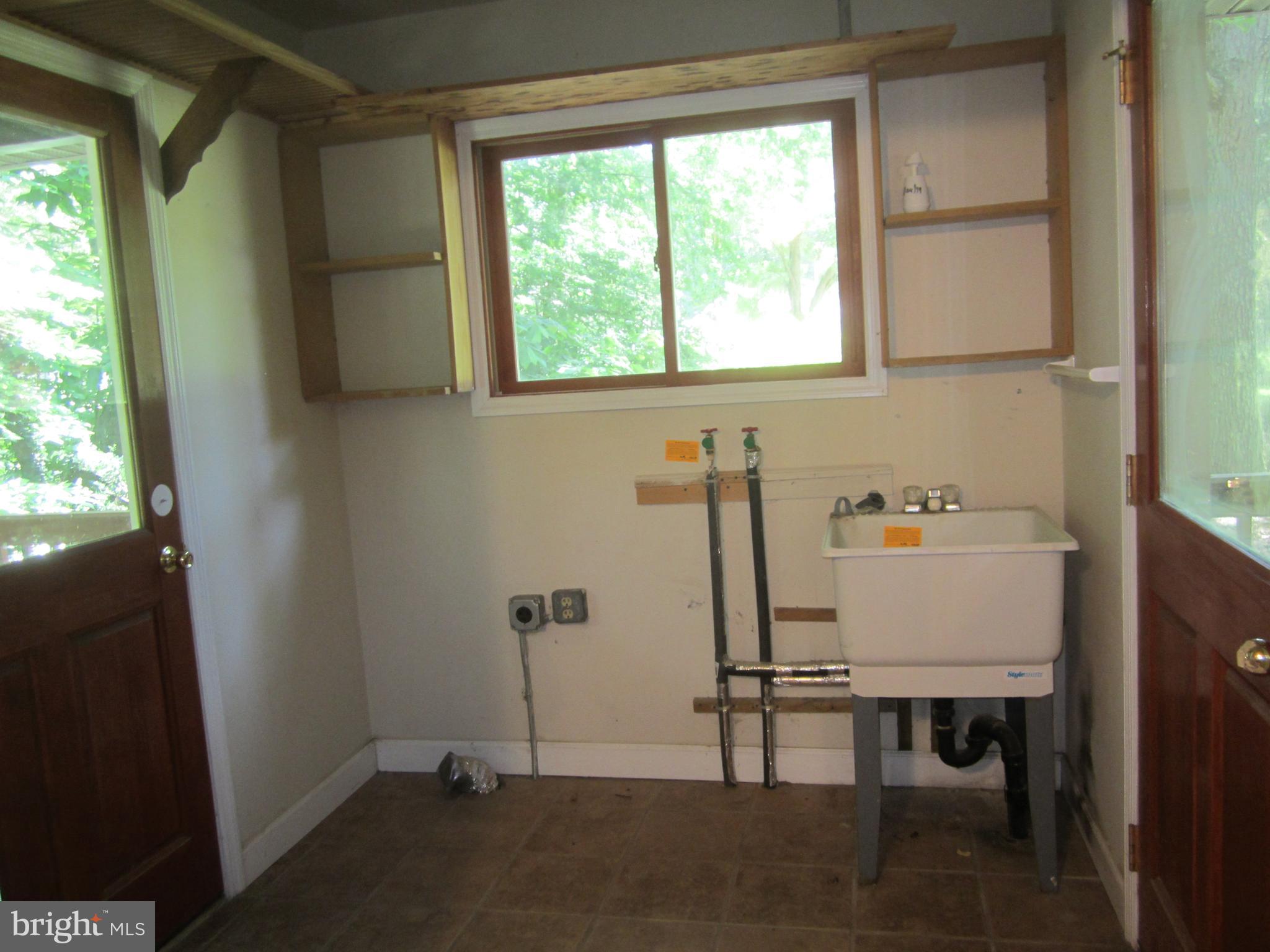 3421 Holland Cliffs Road Huntingtown, MD 20639 - Photo 5 of 19 a view of a room with gym equipment on the wall