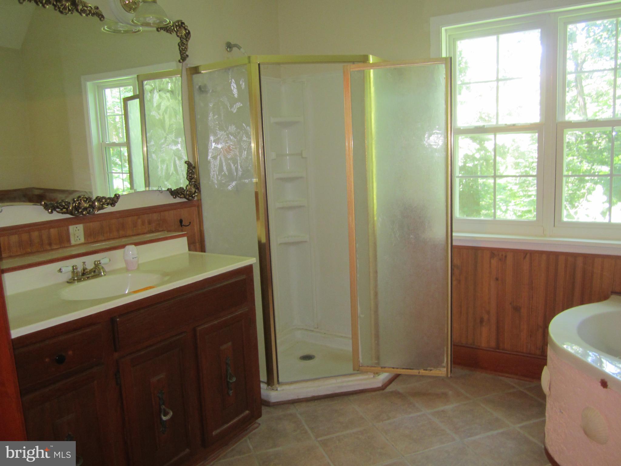3421 Holland Cliffs Road Huntingtown, MD 20639 - Photo 8 of 19 a bathroom with a sink and a mirror