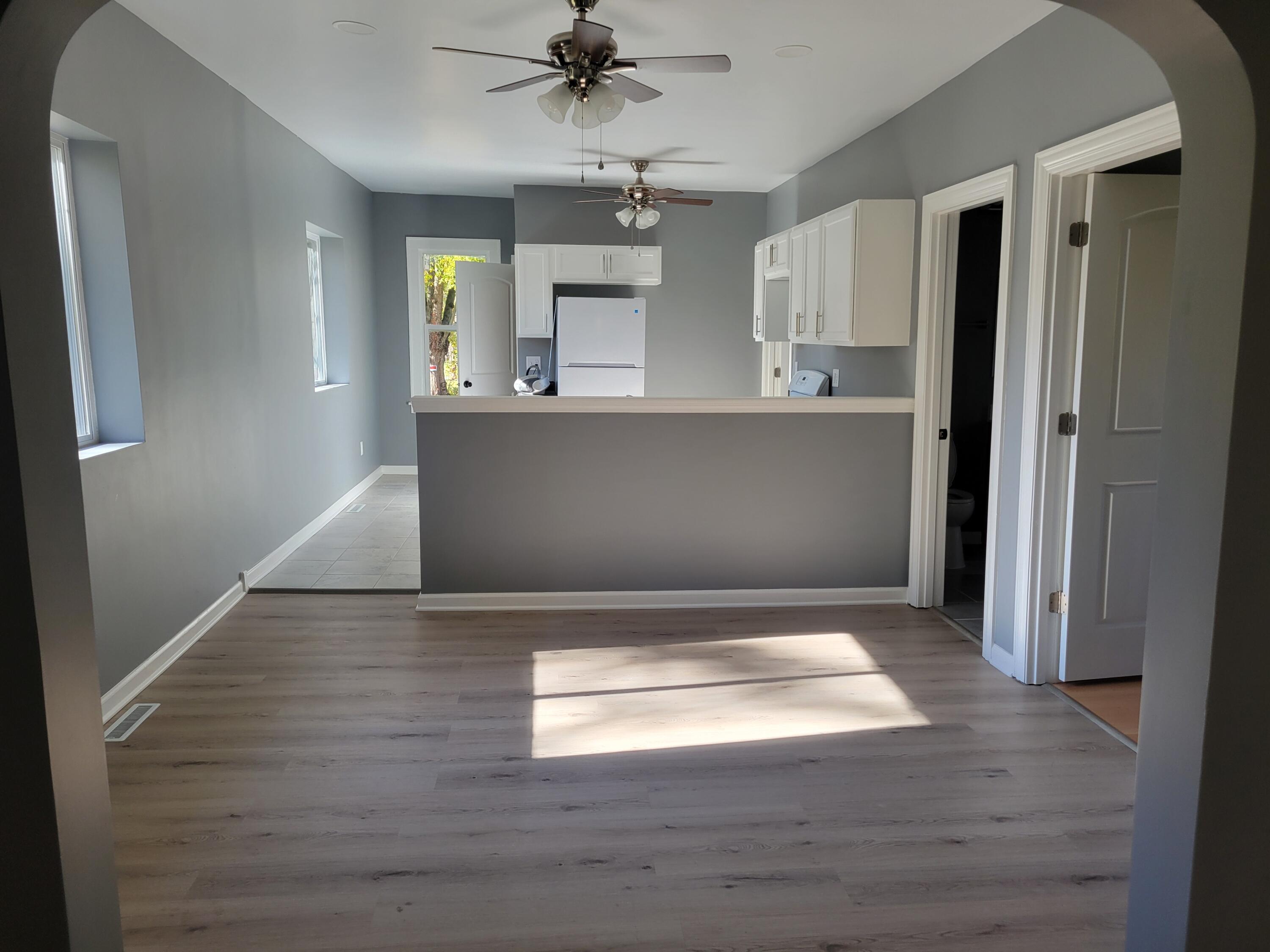 4738 Delaware Street Gary, IN 46409 - Photo 3 of 14 a view of an empty room with wooden floor and a window