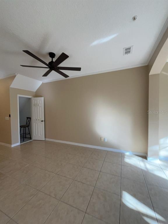 839 Assembly Court Reunion, FL 34747 - Photo 14 of 16 a view of a livingroom with a ceiling fan and window