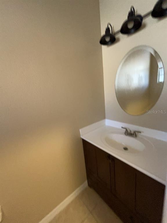 839 Assembly Court Reunion, FL 34747 - Photo 15 of 16 a bathroom with a sink and a mirror