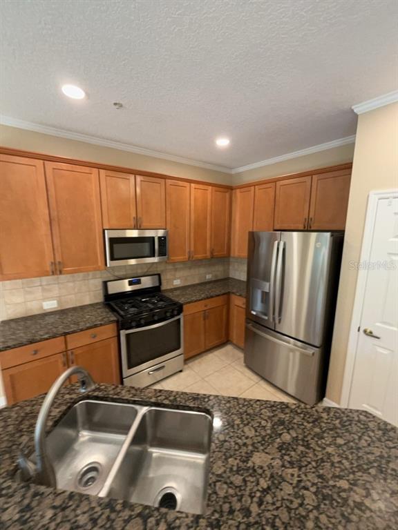 839 Assembly Court Reunion, FL 34747 - Photo 2 of 16 a kitchen with a sink a refrigerator and cabinets