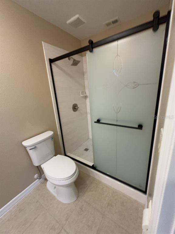839 Assembly Court Reunion, FL 34747 - Photo 7 of 16 a white toilet sitting next to a shower
