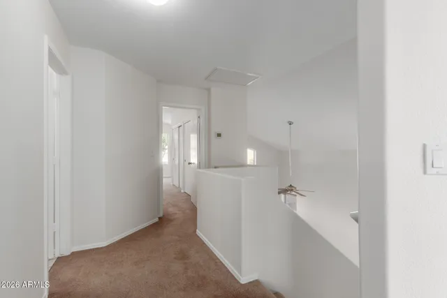a view of a hallway with white walls