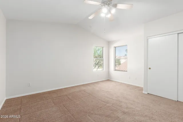 an empty room with windows and closet