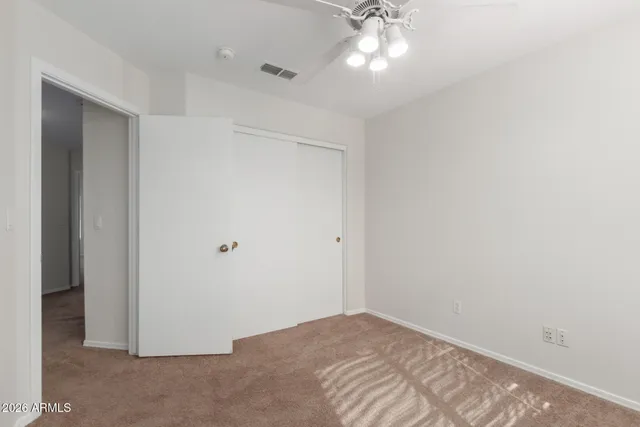 a view of a livingroom with a chandelier fan