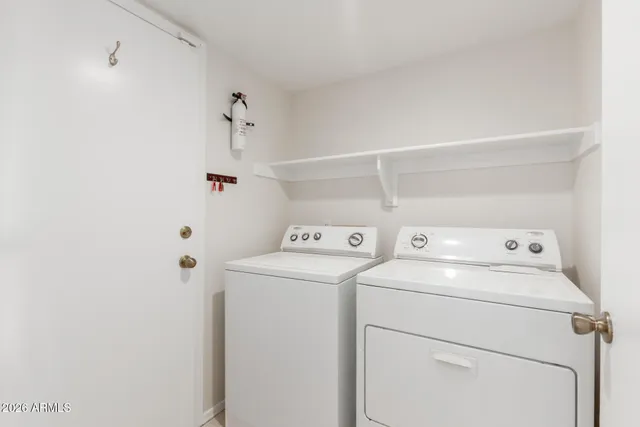 a view of storage and utility room with washer and dryer