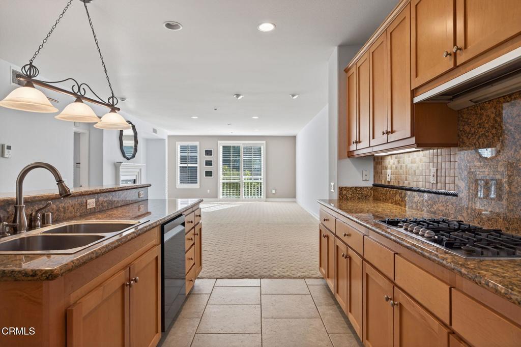1423 Windshore Way Oxnard, CA 93035 - Photo 19 of 77 a kitchen that has a sink and a stove
