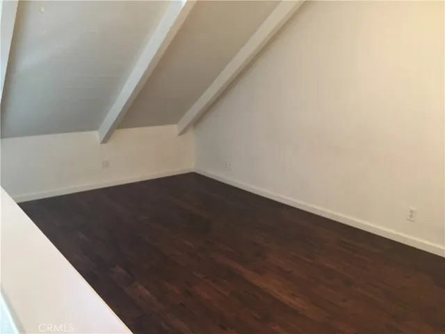a bathroom with a granite countertop sink a toilet and a mirror