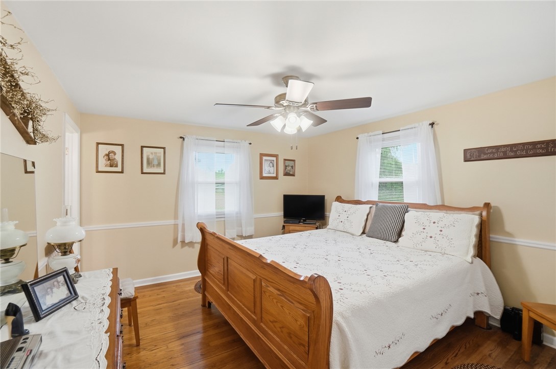 4170 Johnson Road Springfield, OH 45502 - Photo 35 of 54 Hardwood floors and generous windows create a light and welcoming atmosphere in this spacious bedroom.