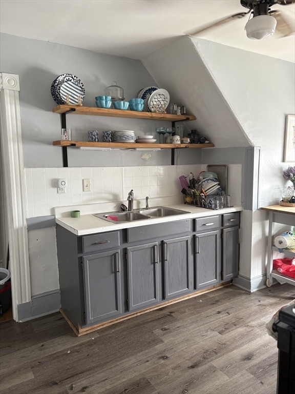 a kitchen with a sink a stove and cabinets