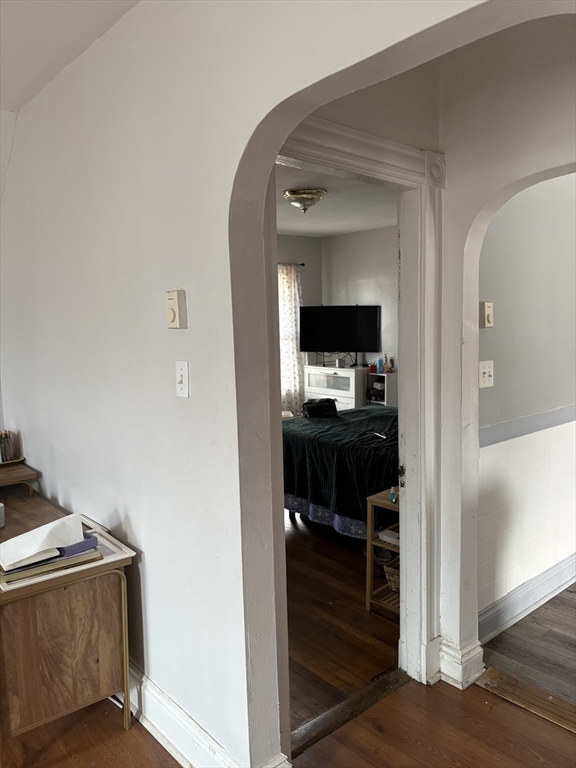 19 Wolcott Street, Unit 3 Boston, MA 02121 - Photo 11 of 17 a view of living room and kitchen with furniture and wooden floor