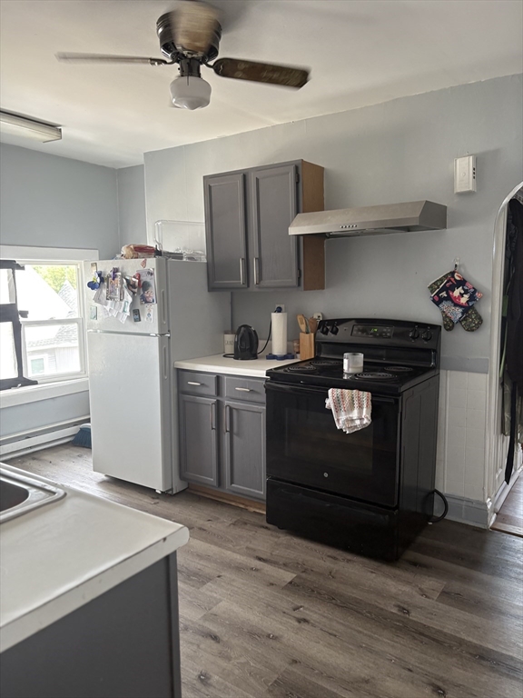 19 Wolcott Street, Unit 3 Boston, MA 02121 - Photo 17 of 17 a kitchen with a stove cabinets and wooden floor