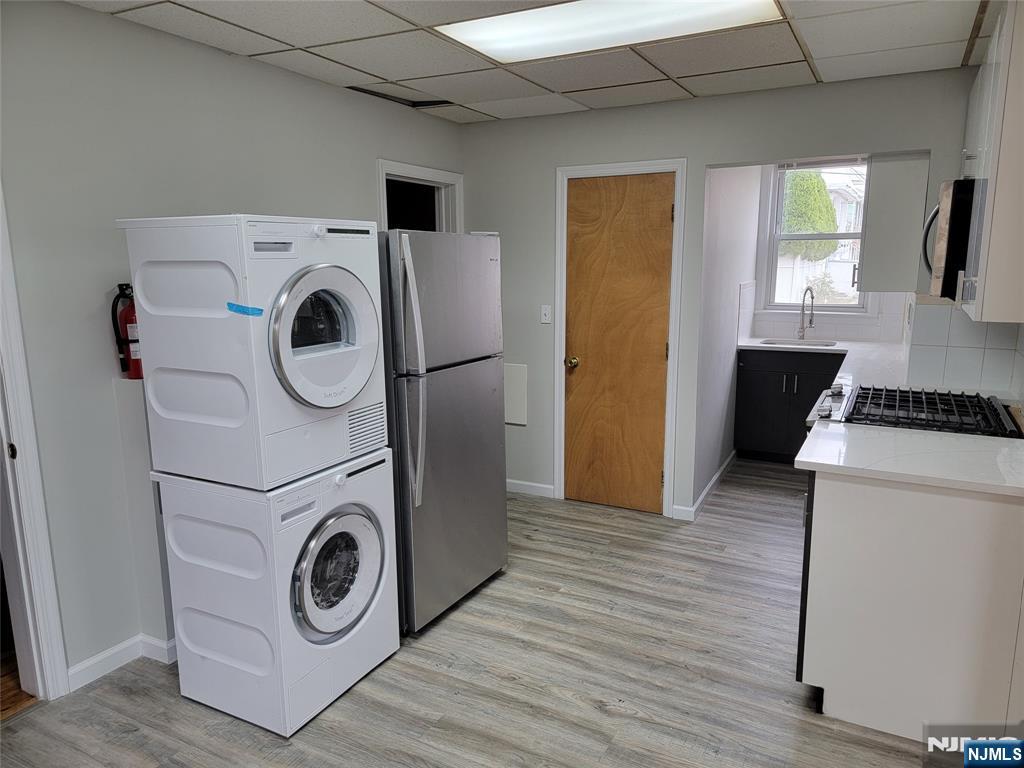 165 Corabelle Avenue, Unit 2 Lodi, NJ 07644 - Photo 3 of 7 a utility room with dryer and washer