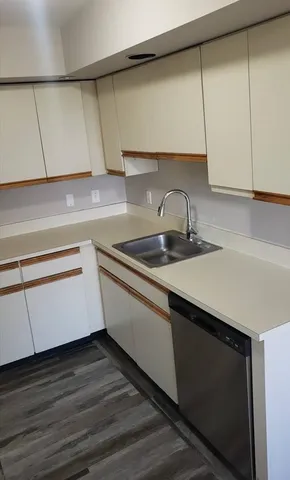 a kitchen with a sink and cabinets