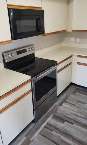a kitchen with a stove and a microwave