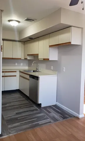 a kitchen with a sink stainless steel appliances and cabinets