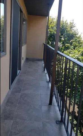 a view of balcony with wooden floor