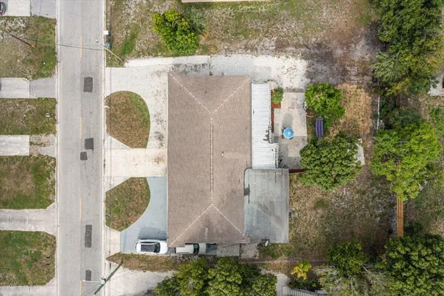 an aerial view of a house with garden space and swimming pool