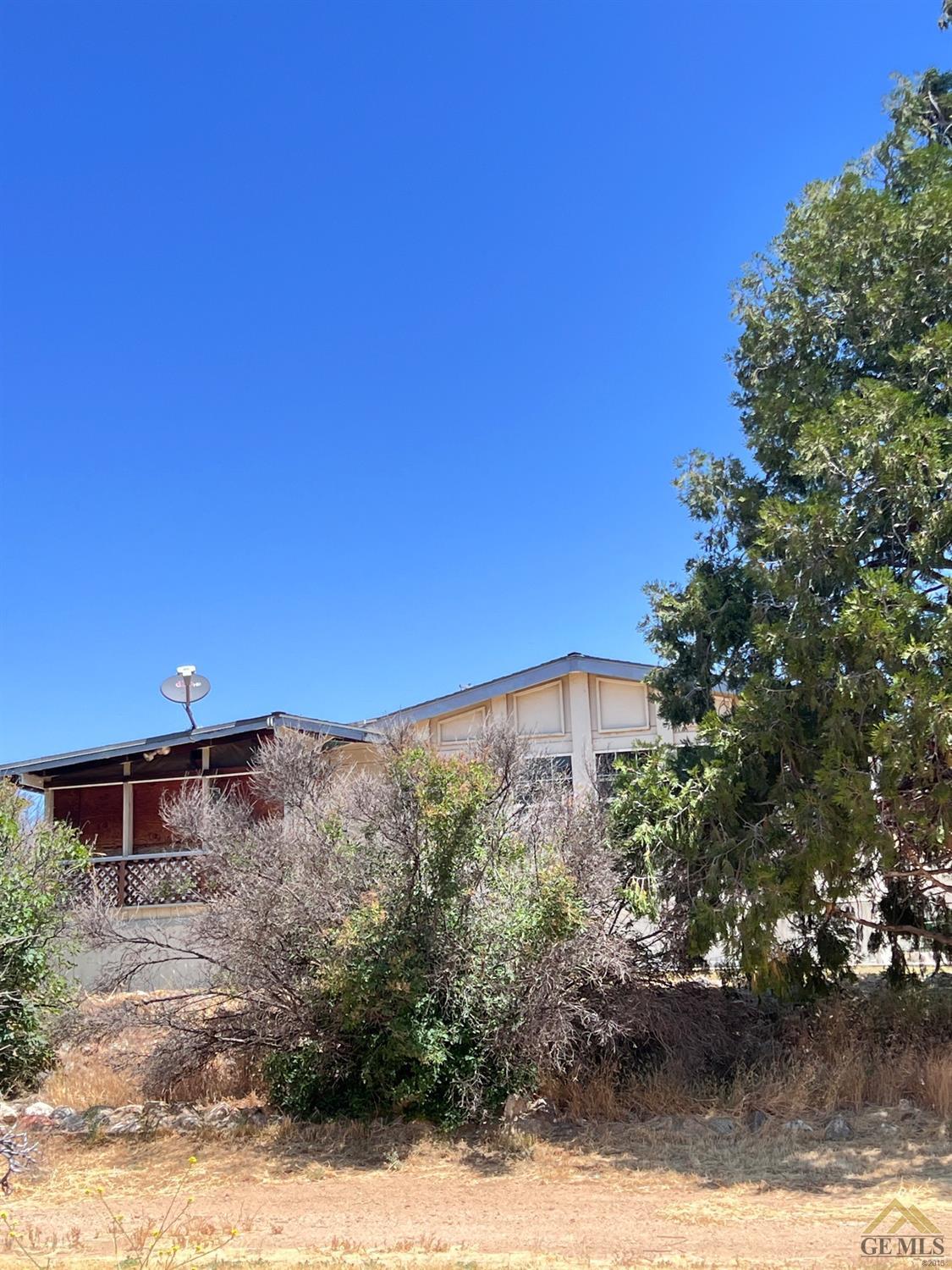 Undisclosed Address Caliente, CA 93518 - Photo 41 of 54 a view of a building with a yard