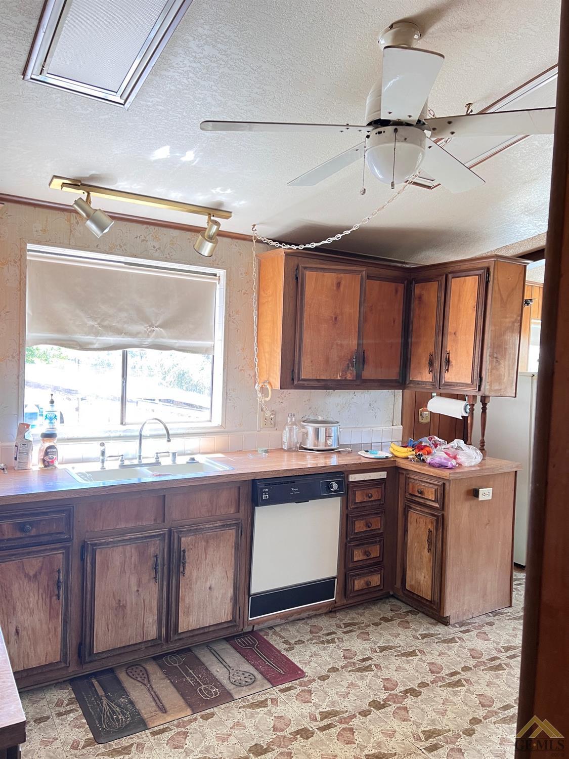 Undisclosed Address Caliente, CA 93518 - Photo 10 of 54 a kitchen with a sink and wooden cabinets