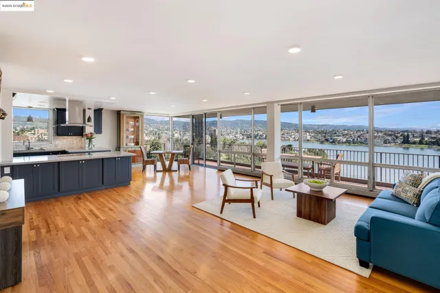 a living room with furniture wooden floor and a large window