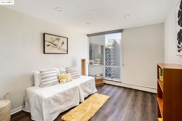 a view of a bedroom with wooden floor and closet