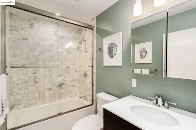 a bathroom with a granite countertop toilet sink and shower