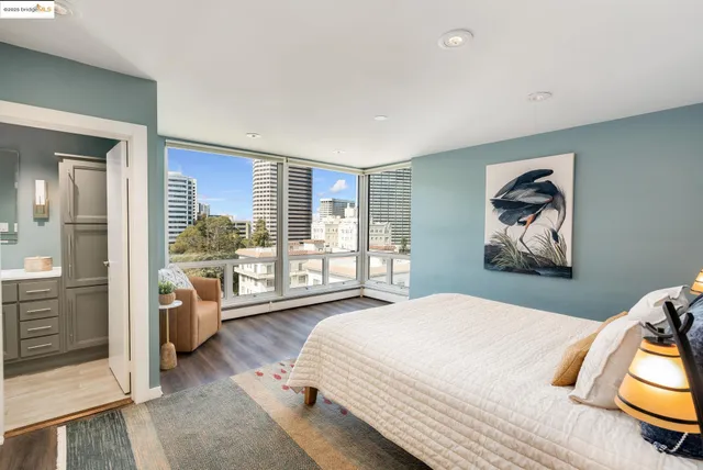 a bedroom with a bed and glass walk in closet