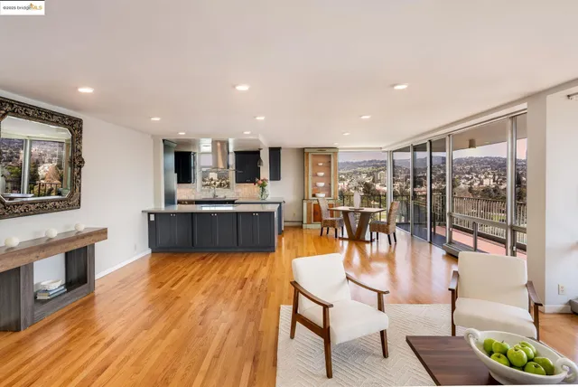 a living room with stainless steel appliances furniture a dining table and chairs