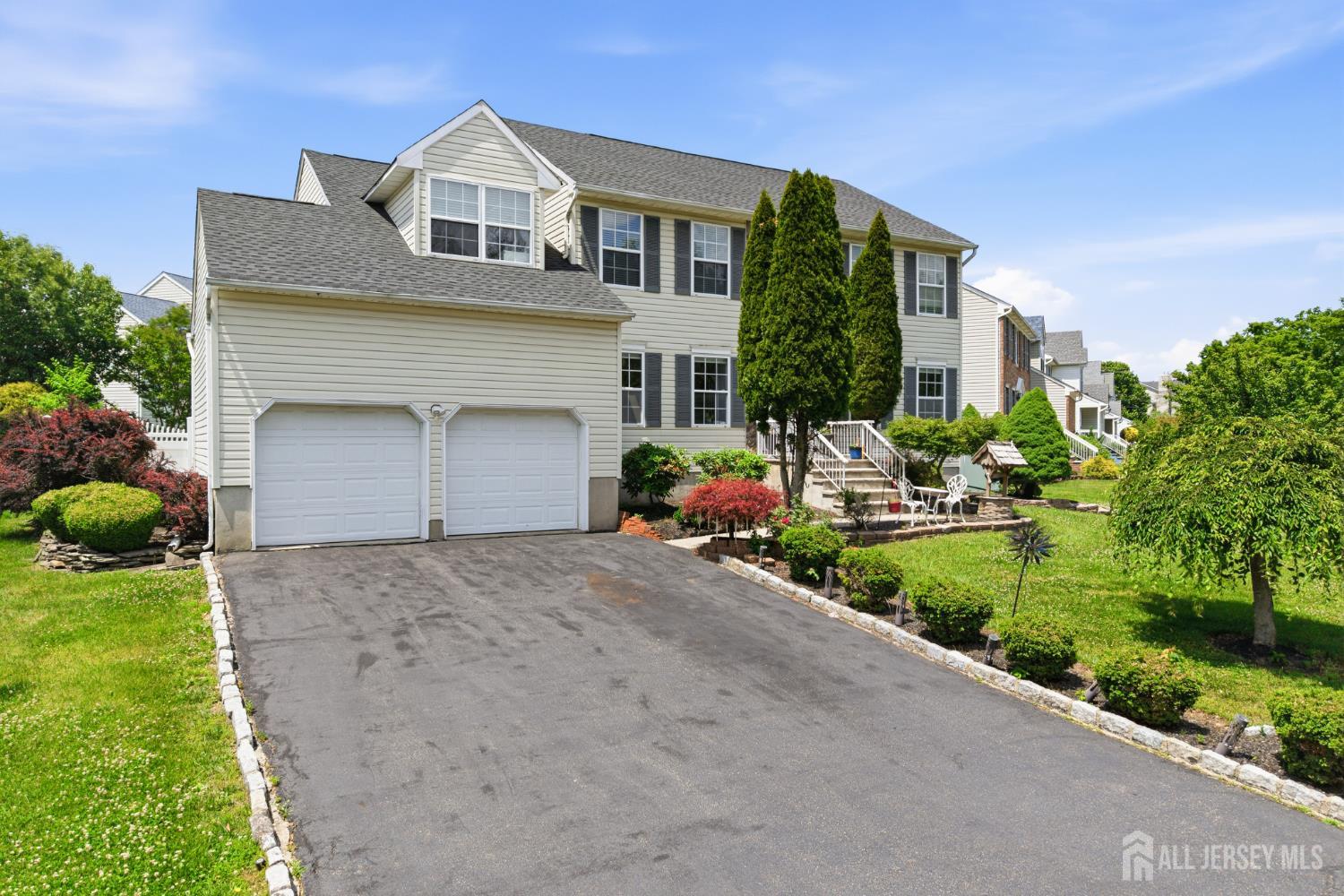 26 Alexis Lane Edison, NJ 08820 - Photo 2 of 39 a front view of a house with a yard and garage