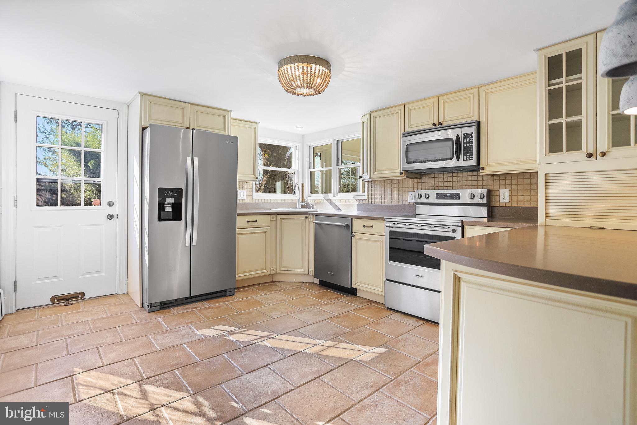 1185 West Street Road West Chester, PA 19382 - Photo 8 of 43 a kitchen with stainless steel appliances granite countertop a refrigerator stove top oven and sink