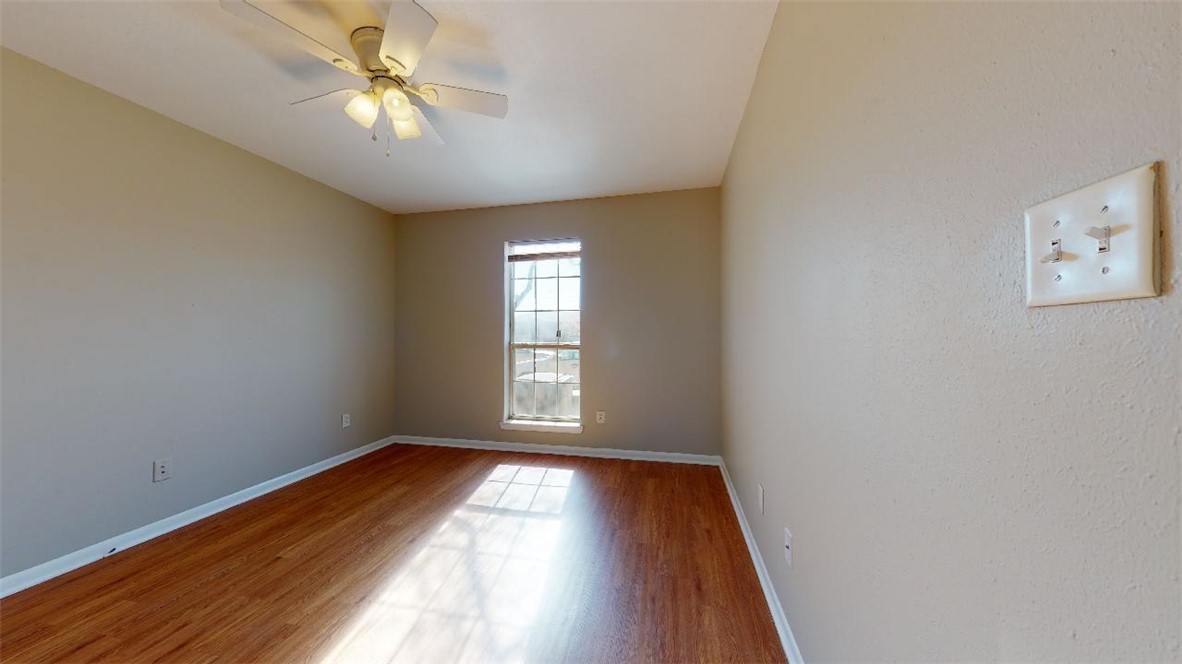 1511 Hollow Hill Drive, Unit B Bryan, TX 77802 - Photo 14 of 22 wooden floor in an empty room with a window