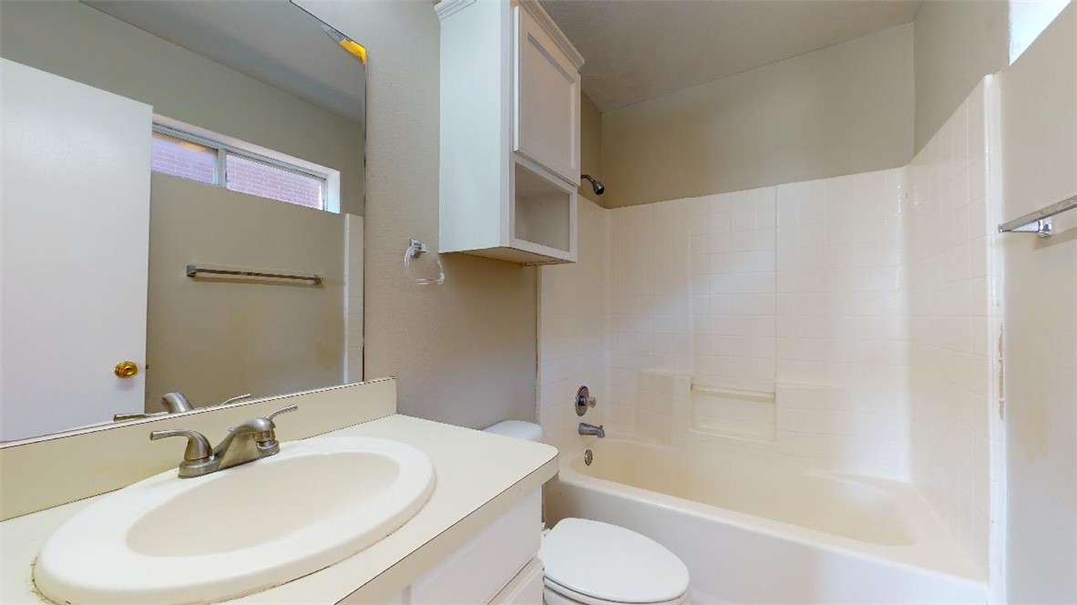 1511 Hollow Hill Drive, Unit B Bryan, TX 77802 - Photo 17 of 22 a bathroom with a sink toilet and shower