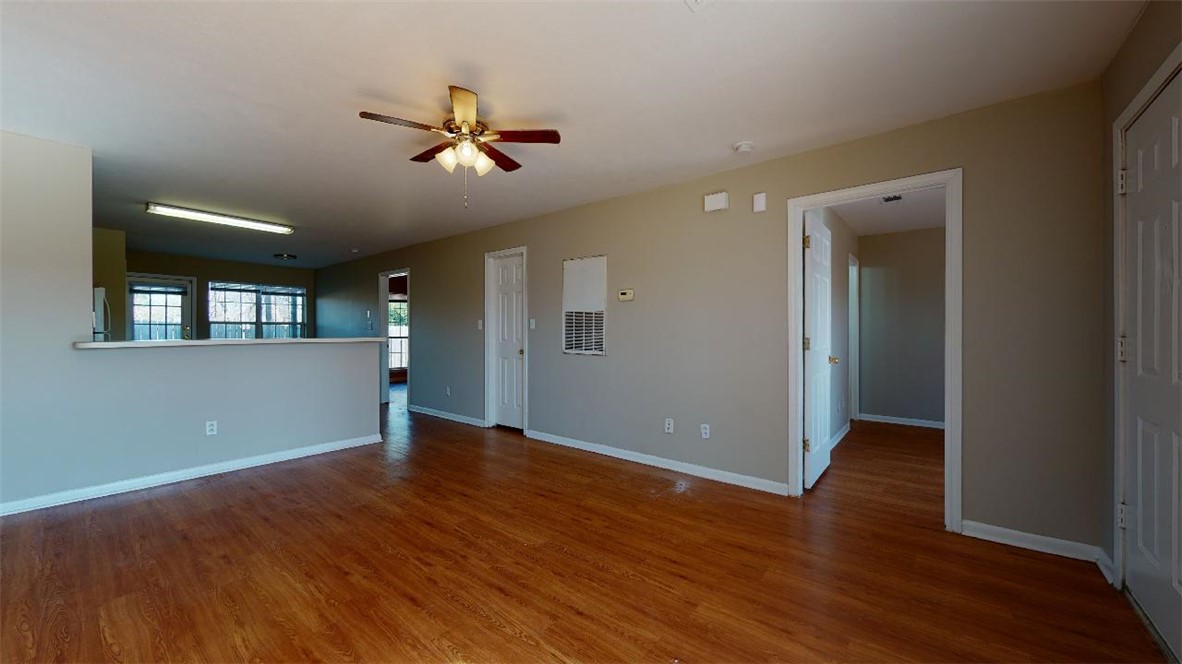 1511 Hollow Hill Drive, Unit B Bryan, TX 77802 - Photo 3 of 22 a view of a big room with wooden floor and windows