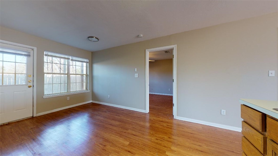 1511 Hollow Hill Drive, Unit B Bryan, TX 77802 - Photo 6 of 22 a view of empty room with wooden floor and fan