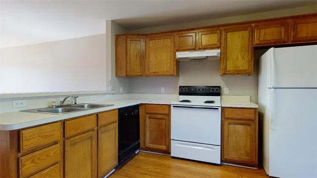 a kitchen with a sink a stove and refrigerator