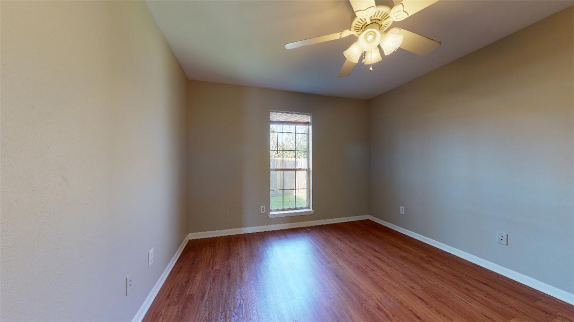 1511 Hollow Hill Drive, Unit B Bryan, TX 77802 - Photo 9 of 22 an empty room with wooden floor and windows