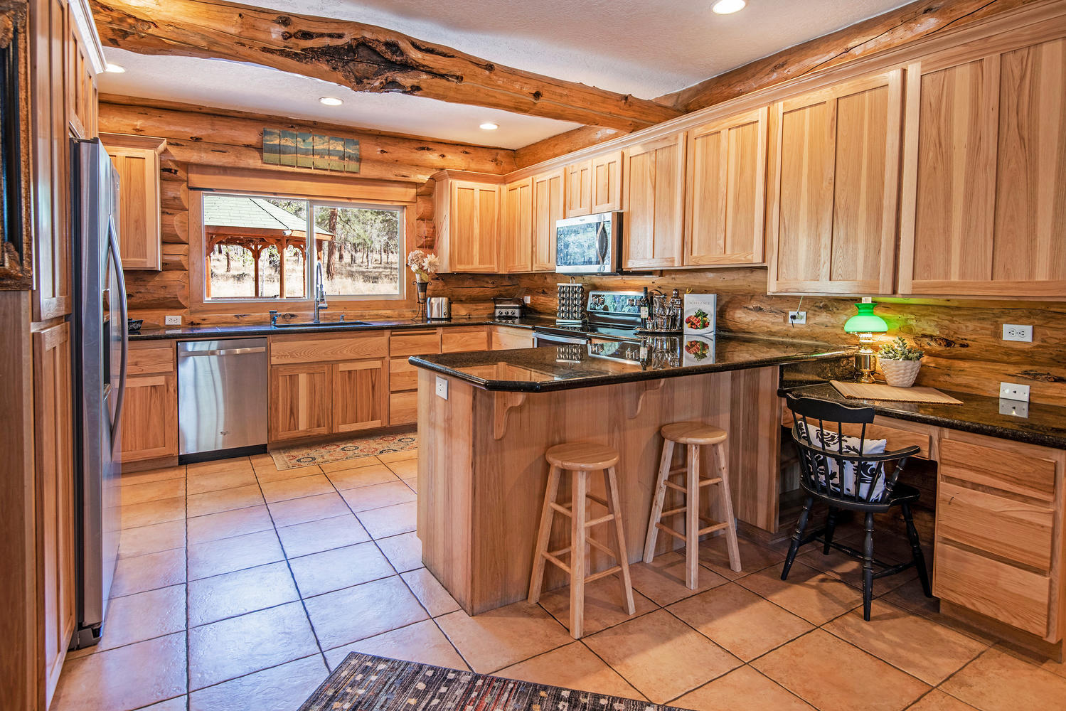 16700 Fair Mile Road Sisters, OR 97759 - Photo 16 of 60 Breakfast Barn, Desk Area, Granite Countertops, Stainless Appliances, Pantry and Access to Covered Patio