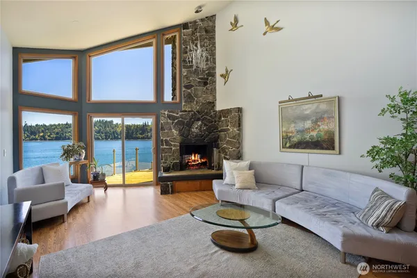 a living room with furniture floor to ceiling window and a flat screen tv