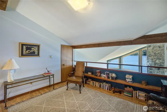 a living room with furniture a rug and a window