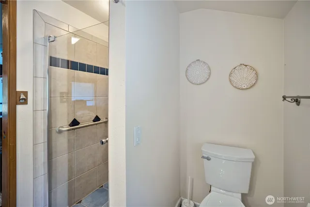 a bathroom with a shower a toilet and sink