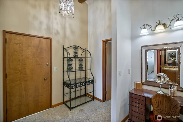 a room with chandelier fan and windows