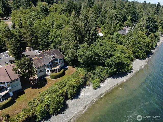 an aerial view of a house with a yard basket ball court and outdoor seating