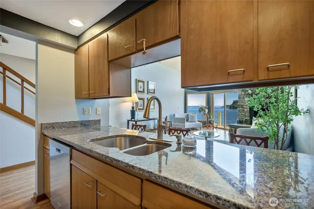 a kitchen with granite countertop a sink and a wooden cabinets