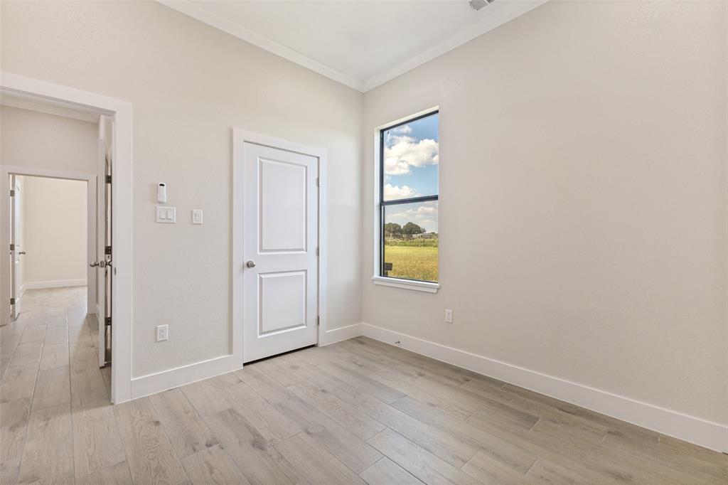 3150 Crisp Road Ennis, TX 75119 - Photo 20 of 30 Light wood-finish flooring with white baseboards and crown molding