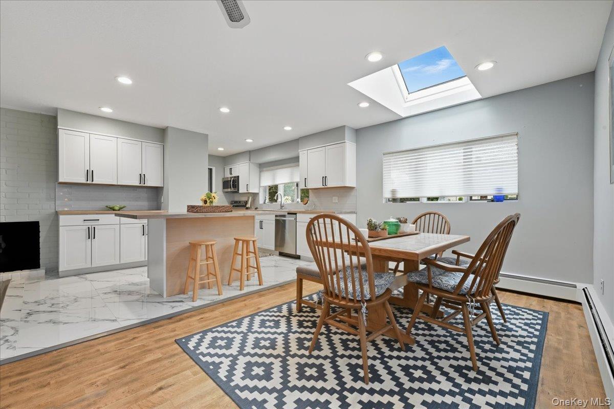16 Ridge Drive East Roslyn, NY 11576 - Photo 11 of 40 a kitchen with granite countertop a table chairs stove a sink and dishwasher